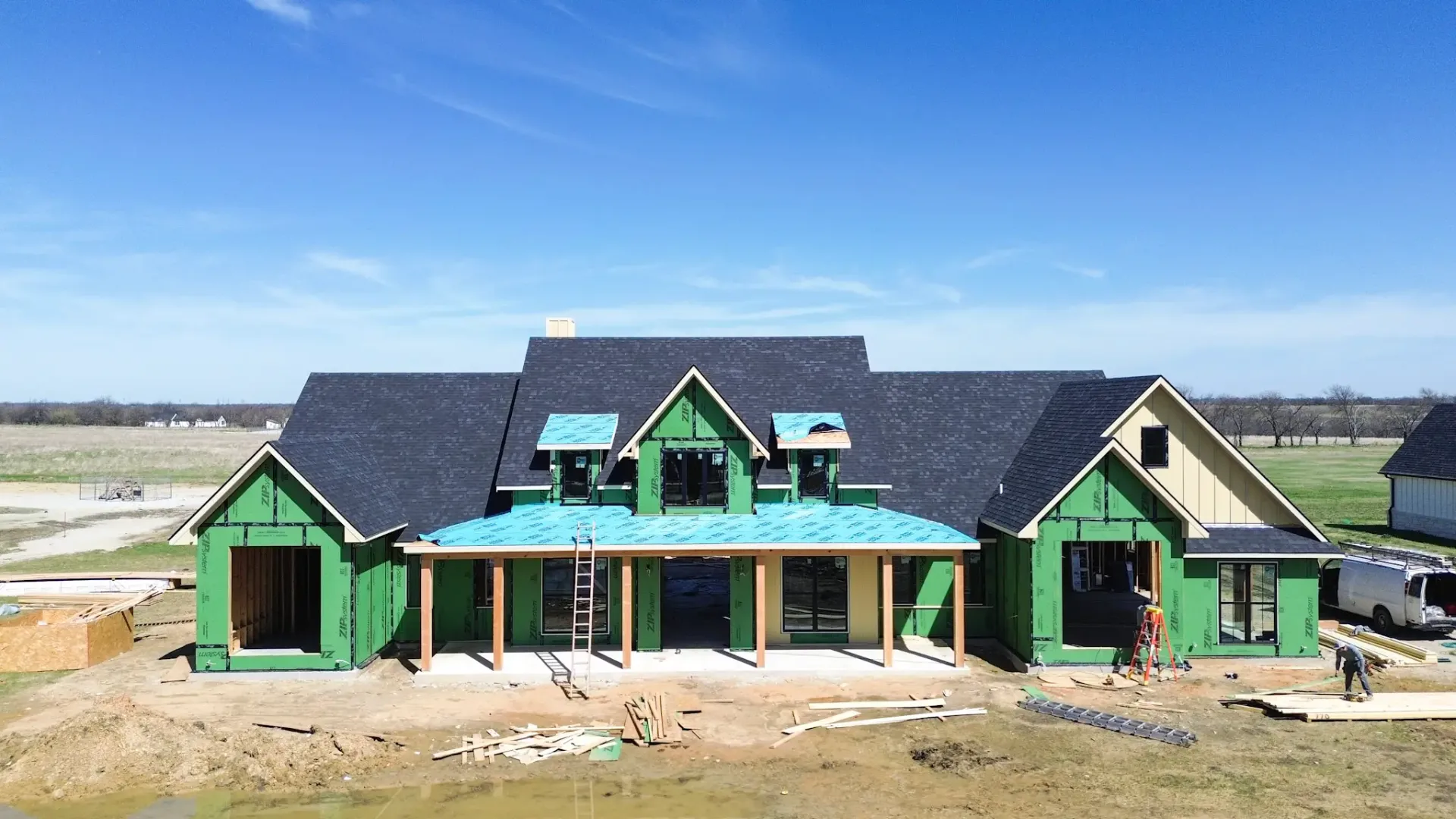 New home under construction with framing crew on site